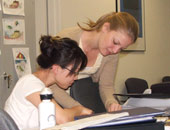 Two staff members discussing a document